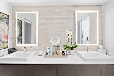 a bathroom with a double vanity sink and a mirror