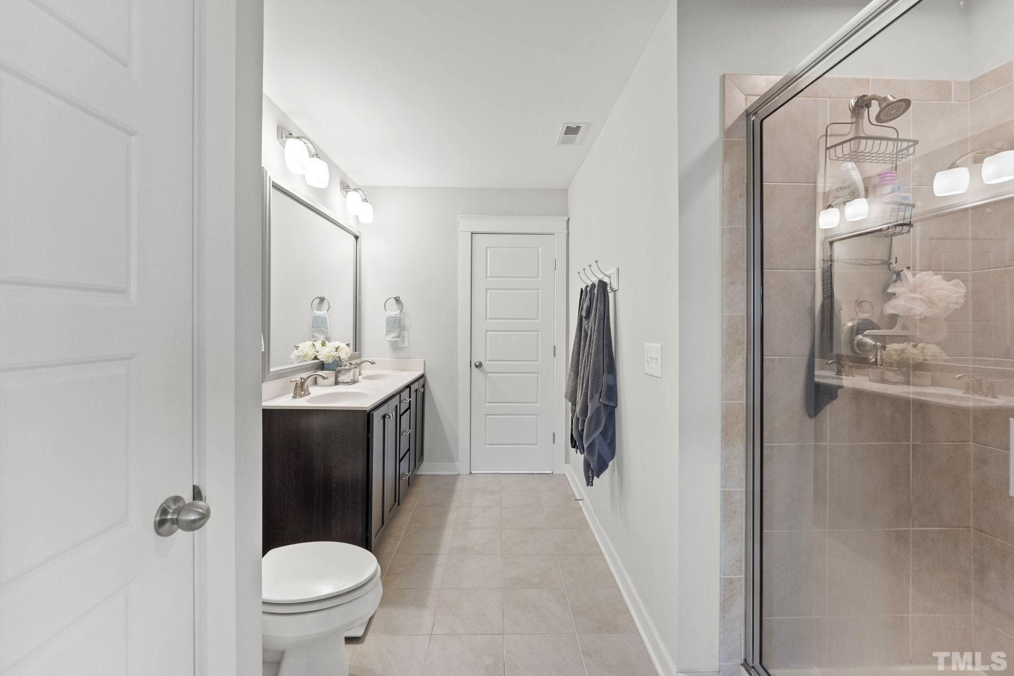 6329 Pesta Court Raleigh, NC 27612 - Photo 12 of 25 a bathroom with a sink a toilet and shower