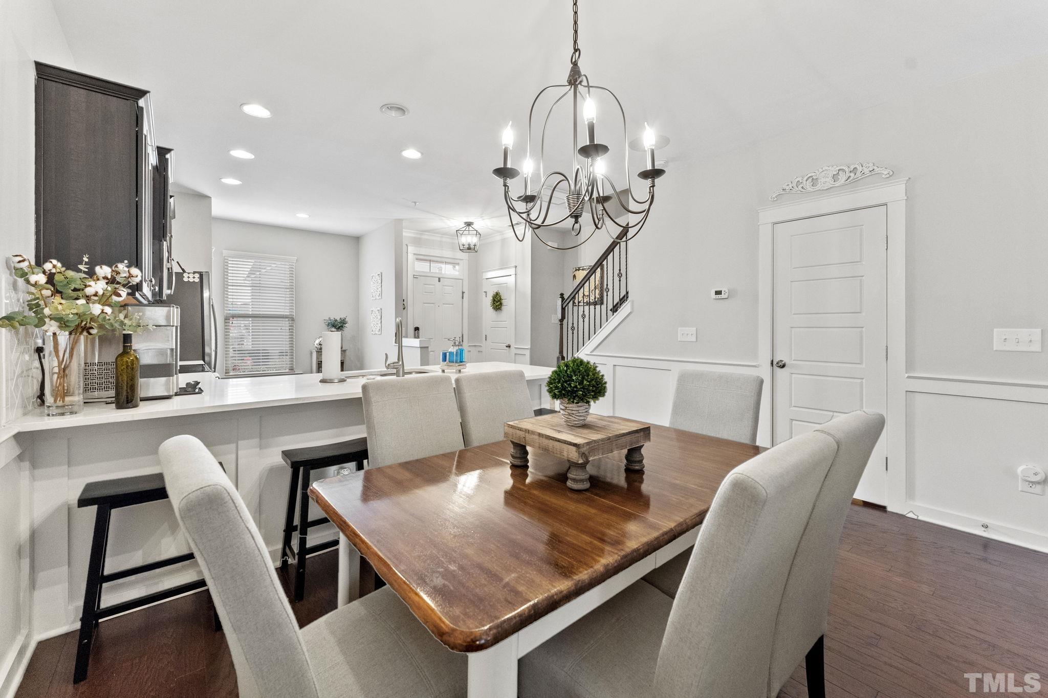 6329 Pesta Court Raleigh, NC 27612 - Photo 5 of 25 a dining room with furniture a chandelier and wooden floor