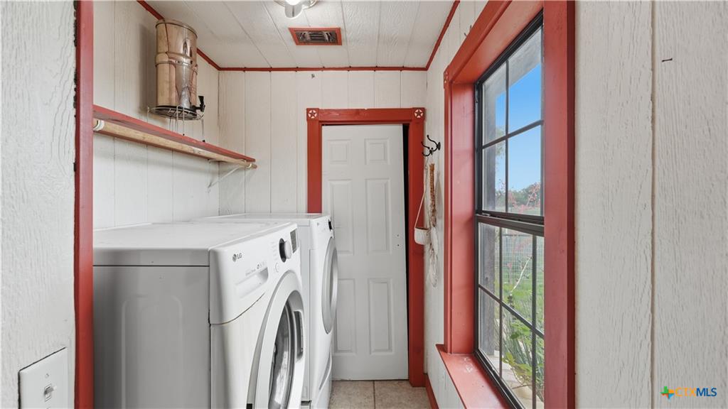 127 Offer Llano, TX 78643 - Photo 23 of 40 Utility space featuring white paneled walls and red trim accents
