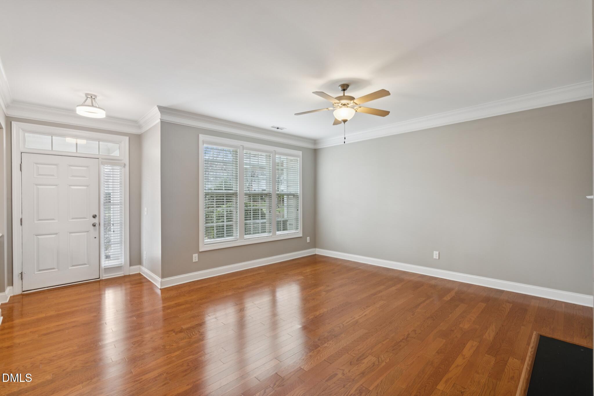 616 Democracy Street Raleigh, NC 27603 - Photo 11 of 61 wooden floor in an empty room with a window