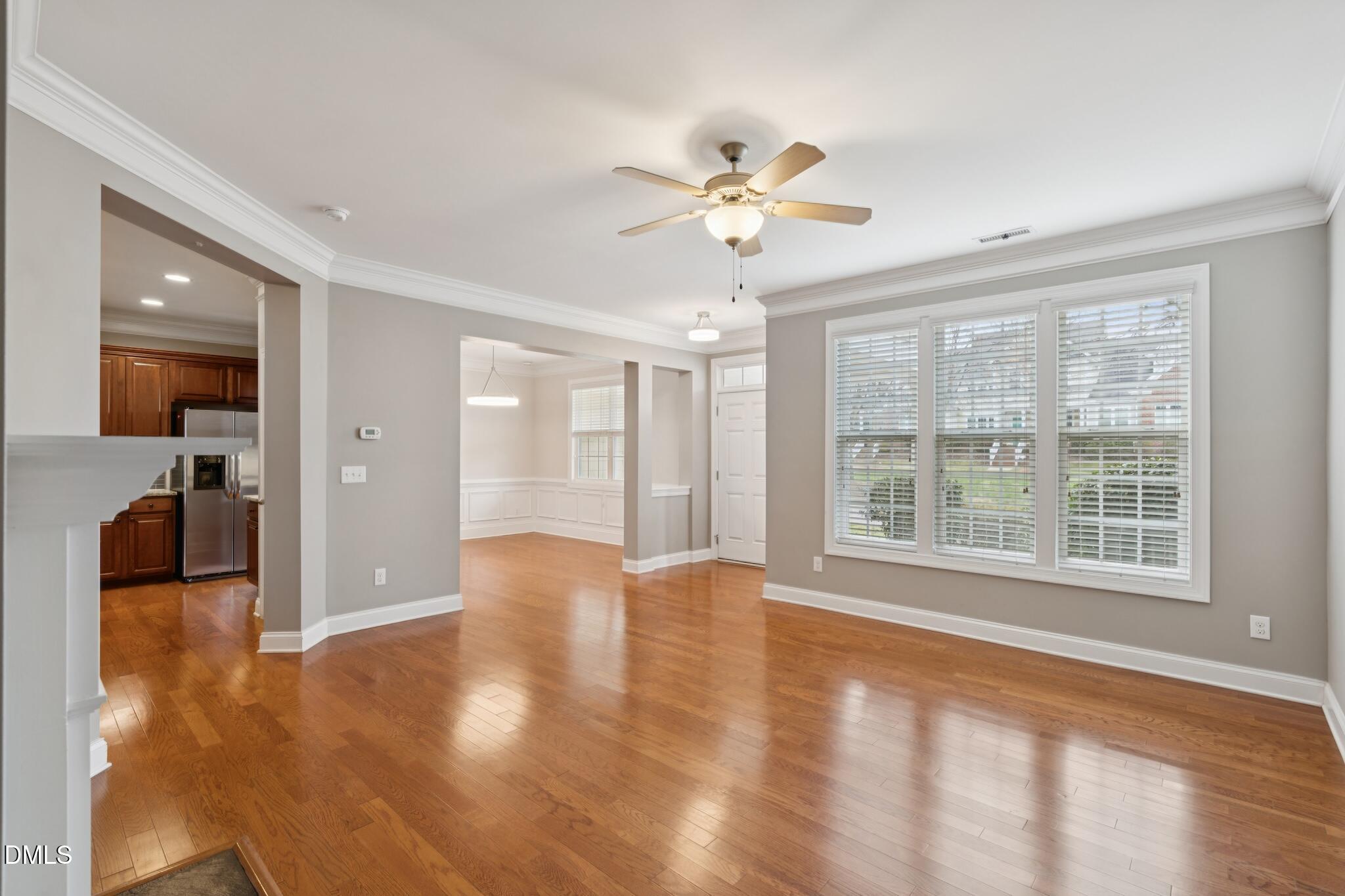616 Democracy Street Raleigh, NC 27603 - Photo 13 of 61 a view of an empty room with window and wooden floor