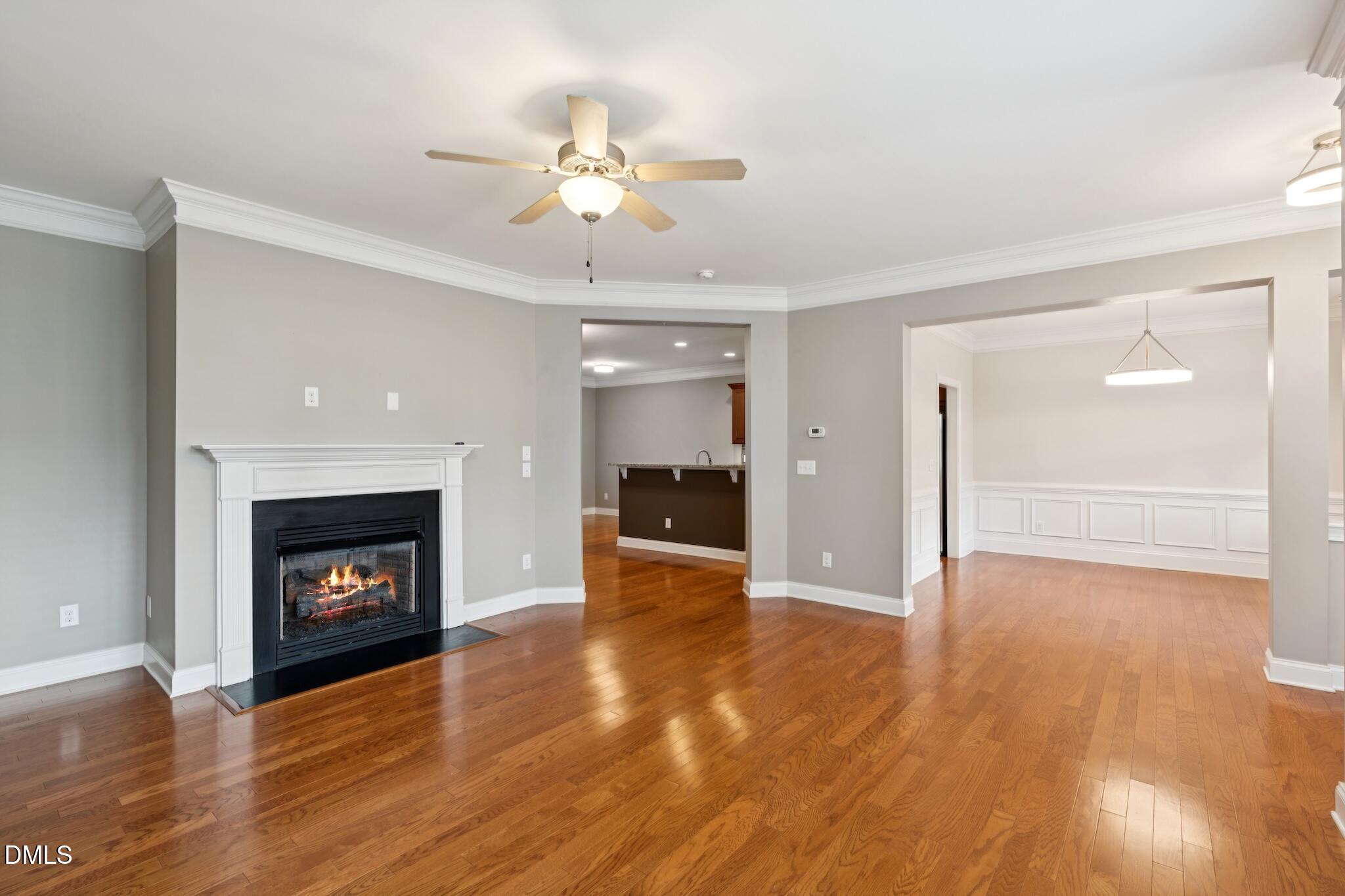616 Democracy Street Raleigh, NC 27603 - Photo 14 of 61 a view of an empty room with wooden floor and fireplace