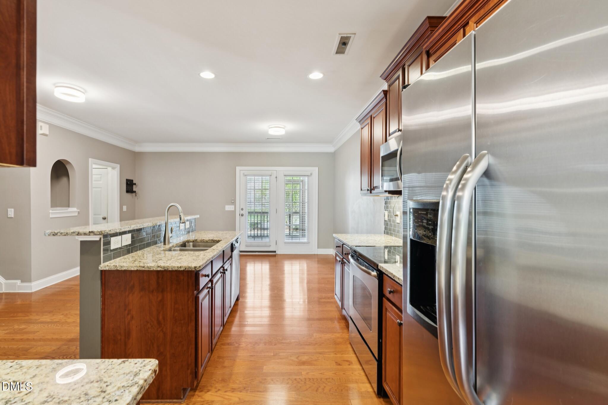 616 Democracy Street Raleigh, NC 27603 - Photo 18 of 61 a kitchen with stainless steel appliances granite countertop a refrigerator and a sink
