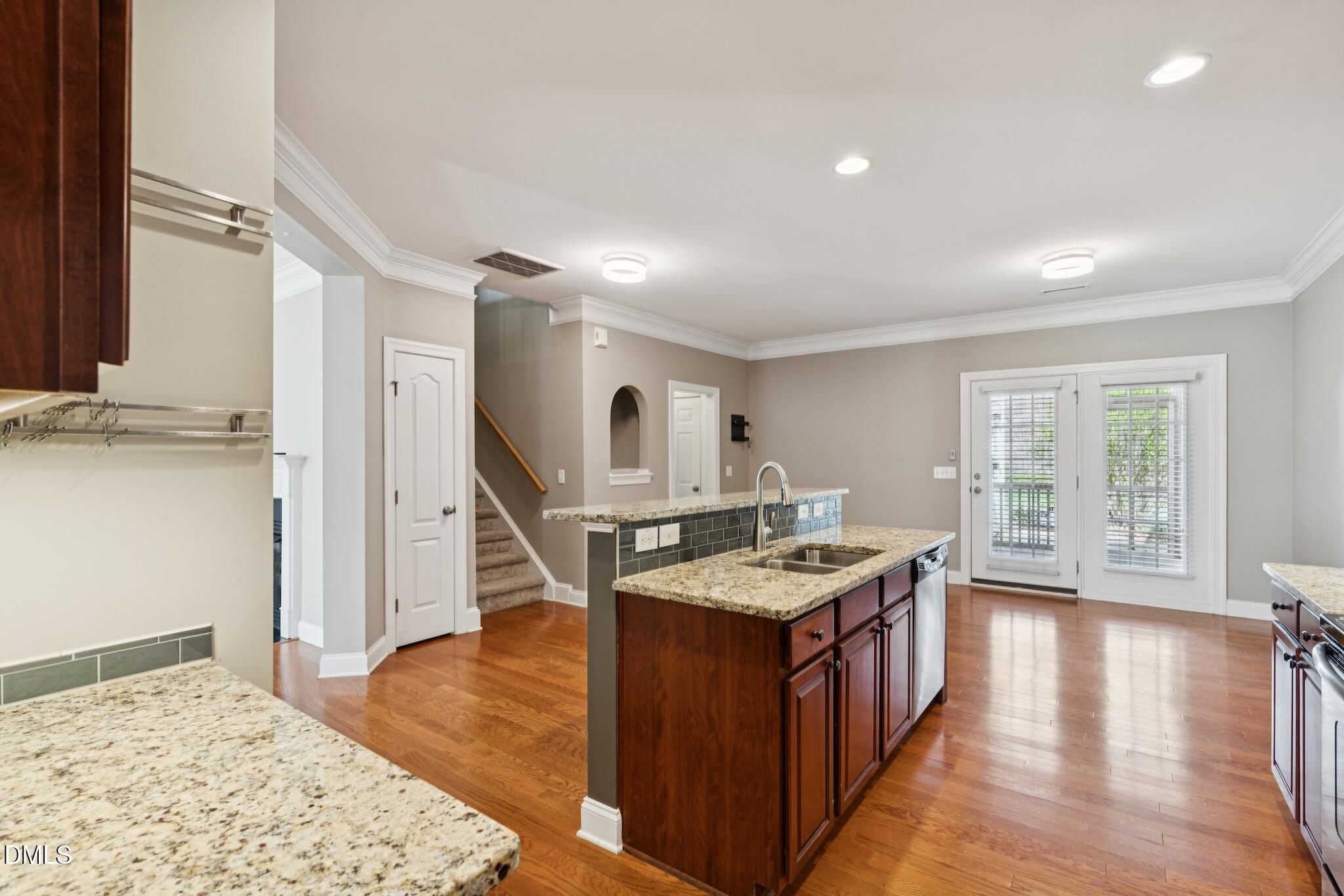 616 Democracy Street Raleigh, NC 27603 - Photo 19 of 61 a living room with stainless steel appliances granite countertop a kitchen island a stove a table and chairs