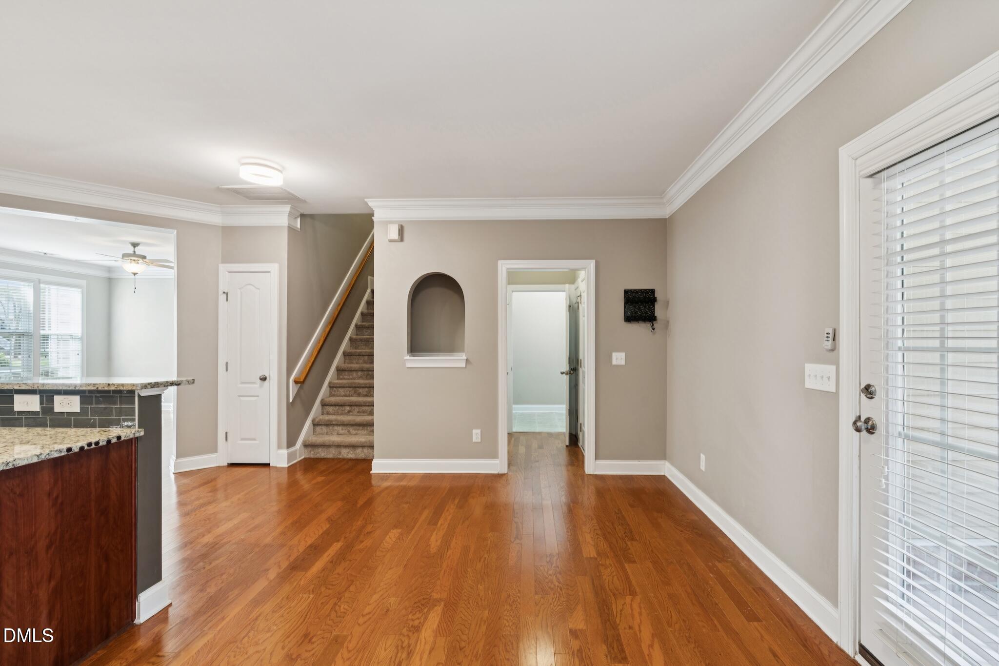 616 Democracy Street Raleigh, NC 27603 - Photo 24 of 61 a view of a livingroom with wooden floor and staircase