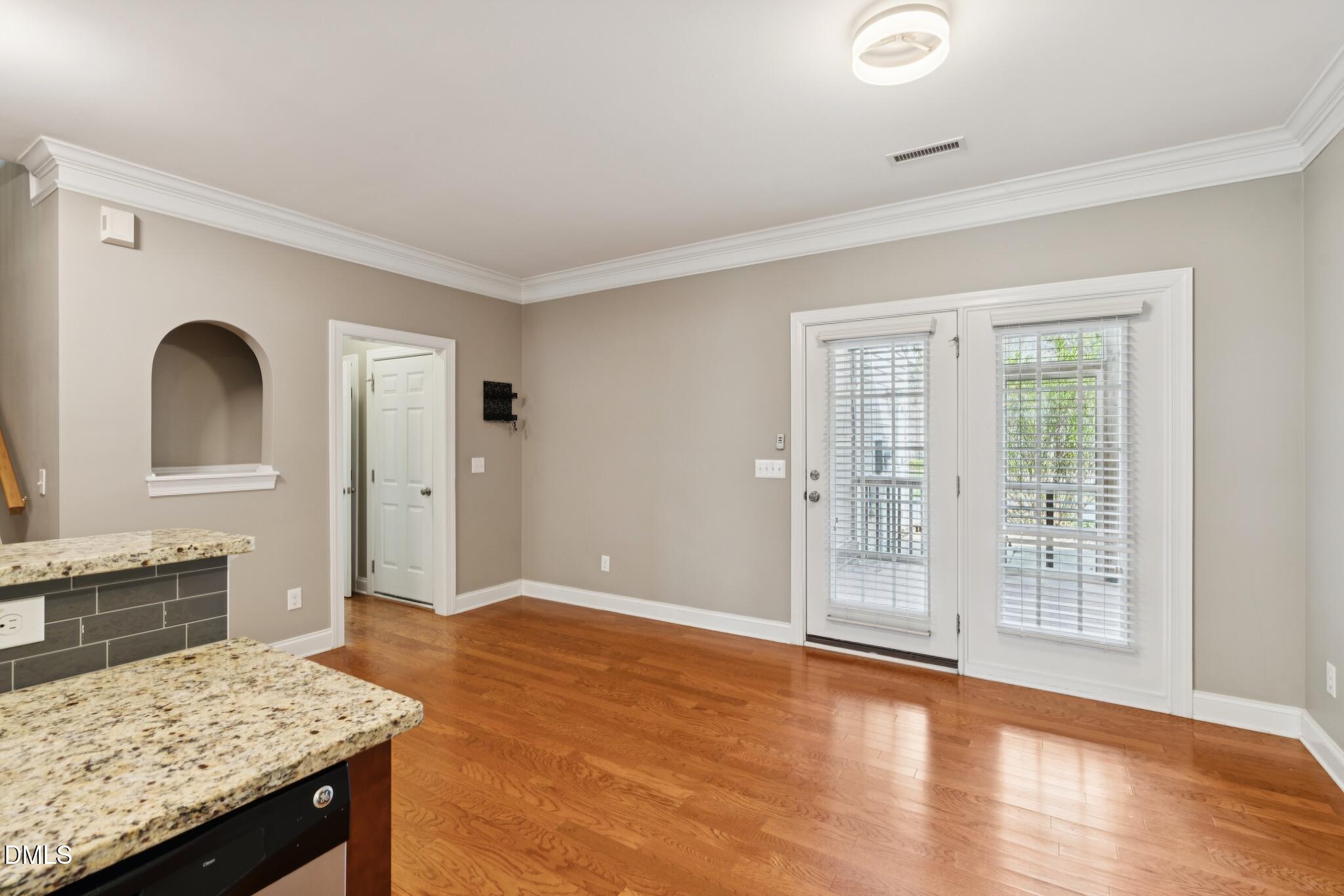 616 Democracy Street Raleigh, NC 27603 - Photo 29 of 61 a view of a kitchen cabinets and wooden floor