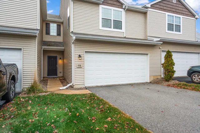 a view of a house with a yard and garage