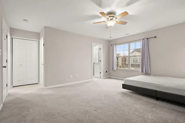 a bedroom with a bed and a painting on the wall