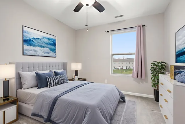 a front view of a house with garden and yard