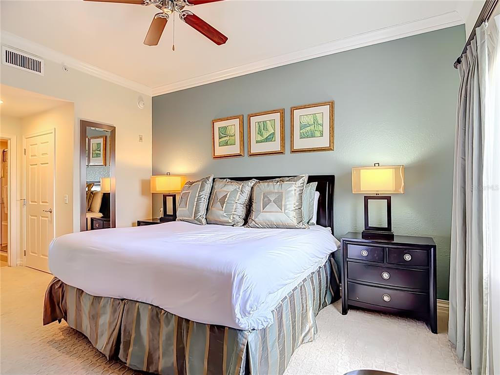 1116 Sunset View Circle, Unit 304 Reunion, FL 34747 - Photo 18 of 37 a bedroom with a bed and a night stand