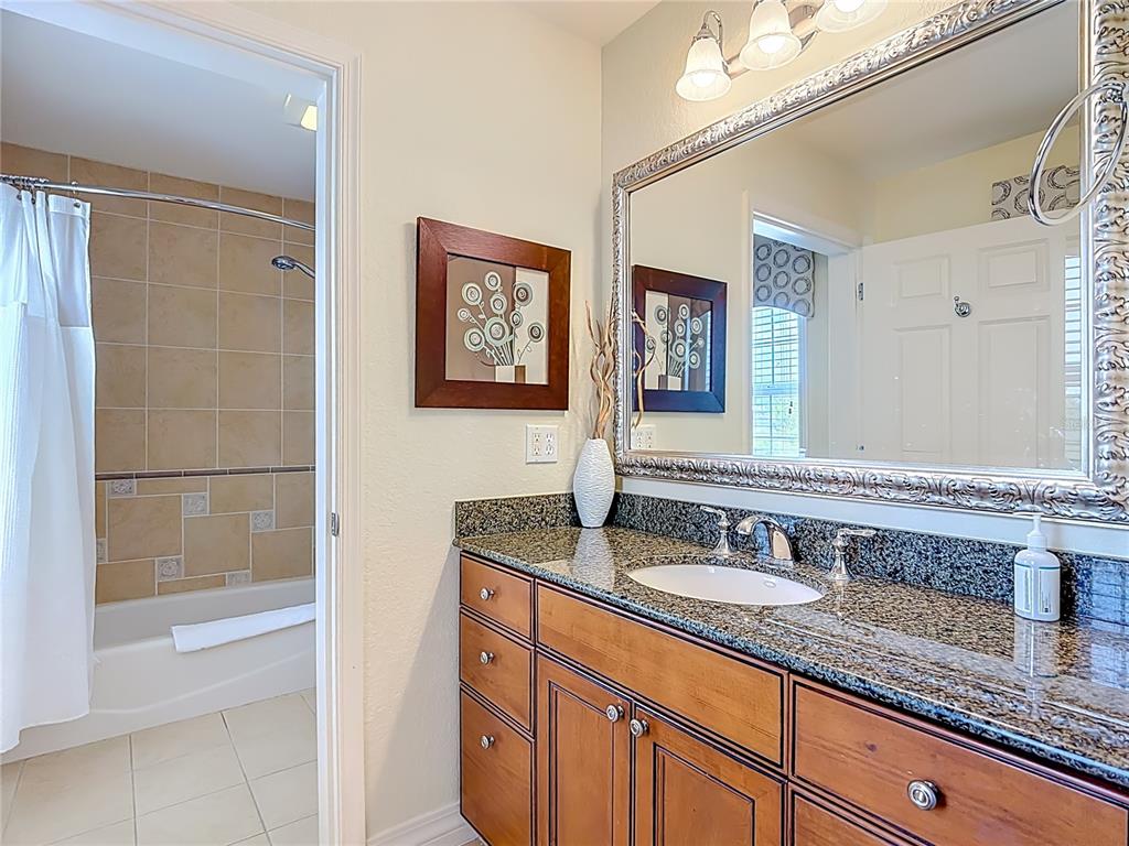 1116 Sunset View Circle, Unit 304 Reunion, FL 34747 - Photo 23 of 37 a bathroom with a granite countertop sink mirror and double