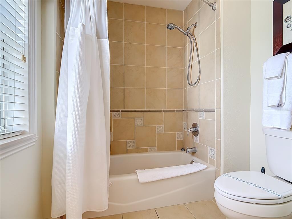 1116 Sunset View Circle, Unit 304 Reunion, FL 34747 - Photo 24 of 37 a bathroom with a bathtub and a shower