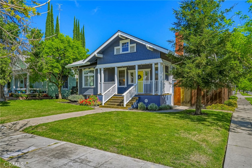 a view of a house with a yard and sitting area