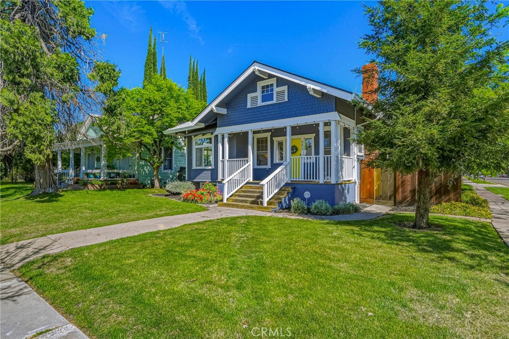 303 West 21st Street Merced, CA 95340 - Photo 3 of 52 a view of a house with a yard and a large tree