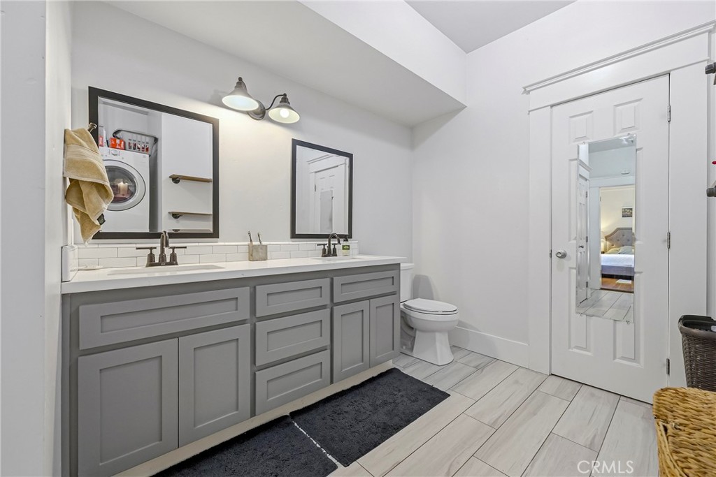 303 West 21st Street Merced, CA 95340 - Photo 33 of 52 a bathroom with a double vanity sink and a mirror