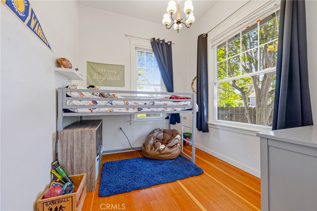 303 West 21st Street Merced, CA 95340 - Photo 40 of 52 a view of a dining room with furniture a chandelier and wooden floor