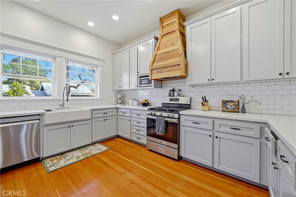 303 West 21st Street Merced, CA 95340 - Photo 45 of 52 a kitchen with stainless steel appliances granite countertop a stove sink and cabinets