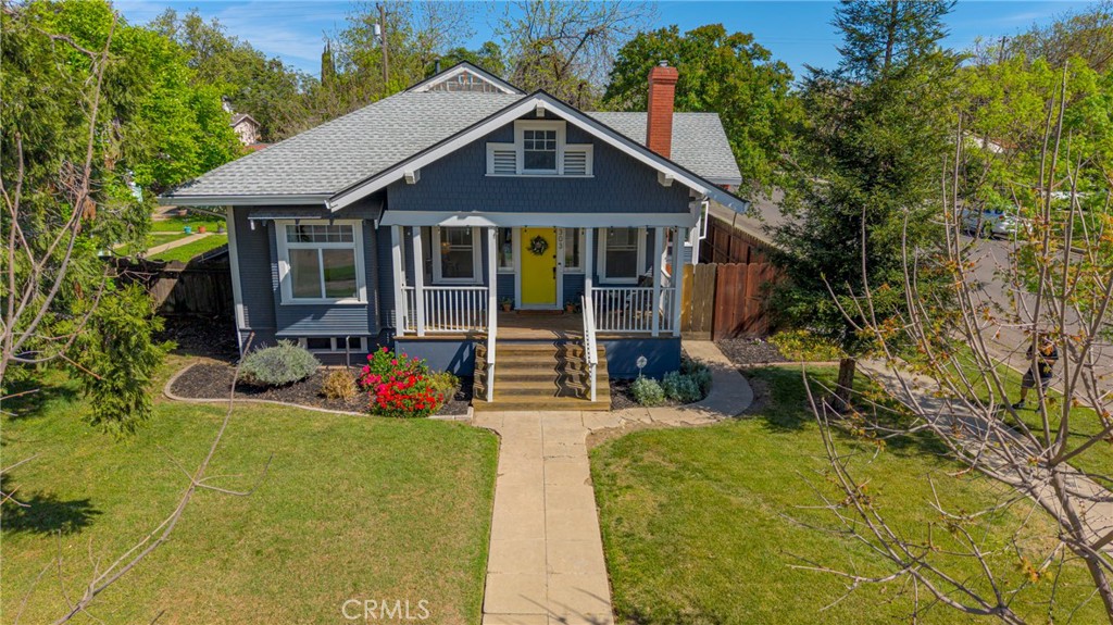 303 West 21st Street Merced, CA 95340 - Photo 8 of 52 a front view of a house with porch and garden