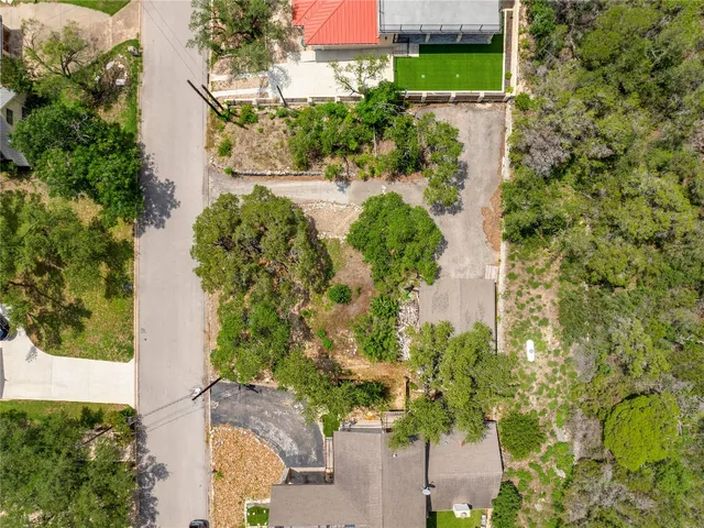 an aerial view of a residential houses with yard