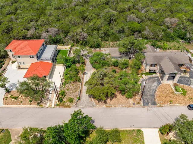 an aerial view of residential houses with outdoor space and street view