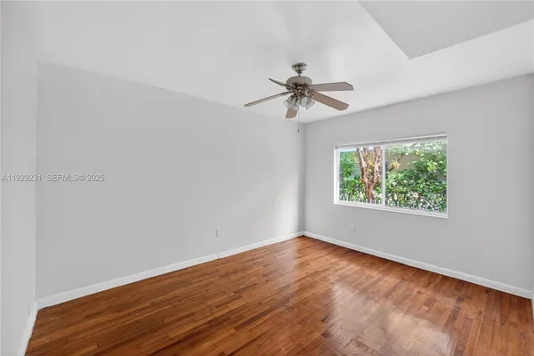 a view of room with hardwood floor and window