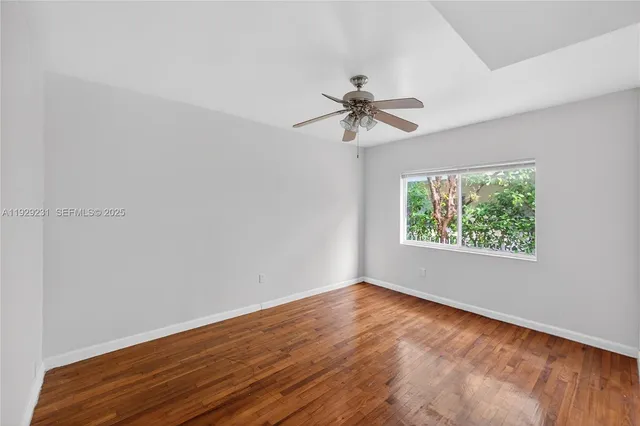 a view of room with hardwood floor and window