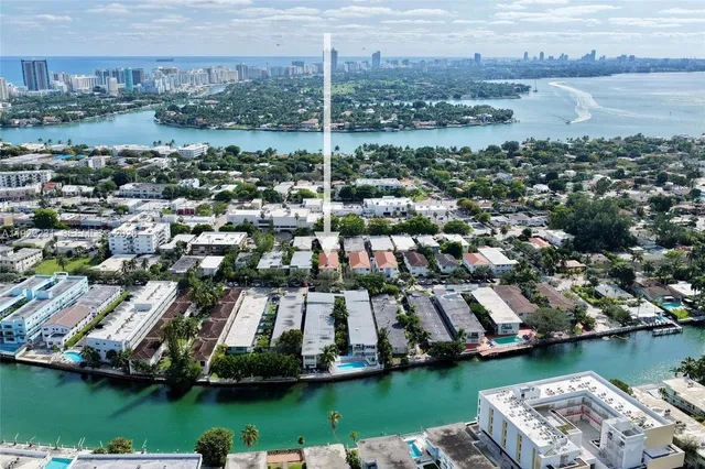 an aerial view of residential houses with outdoor space and lake view