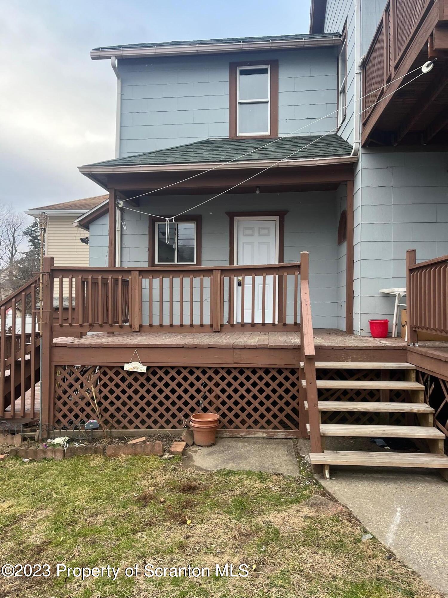 a view of a house with a small deck