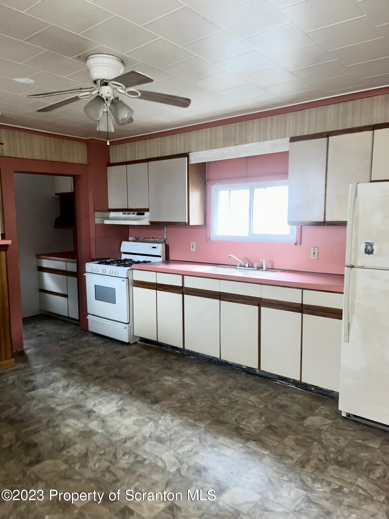 1803 Jackson Street Scranton, PA 18504 - Photo 2 of 8 a kitchen with stainless steel appliances granite countertop a sink and cabinets