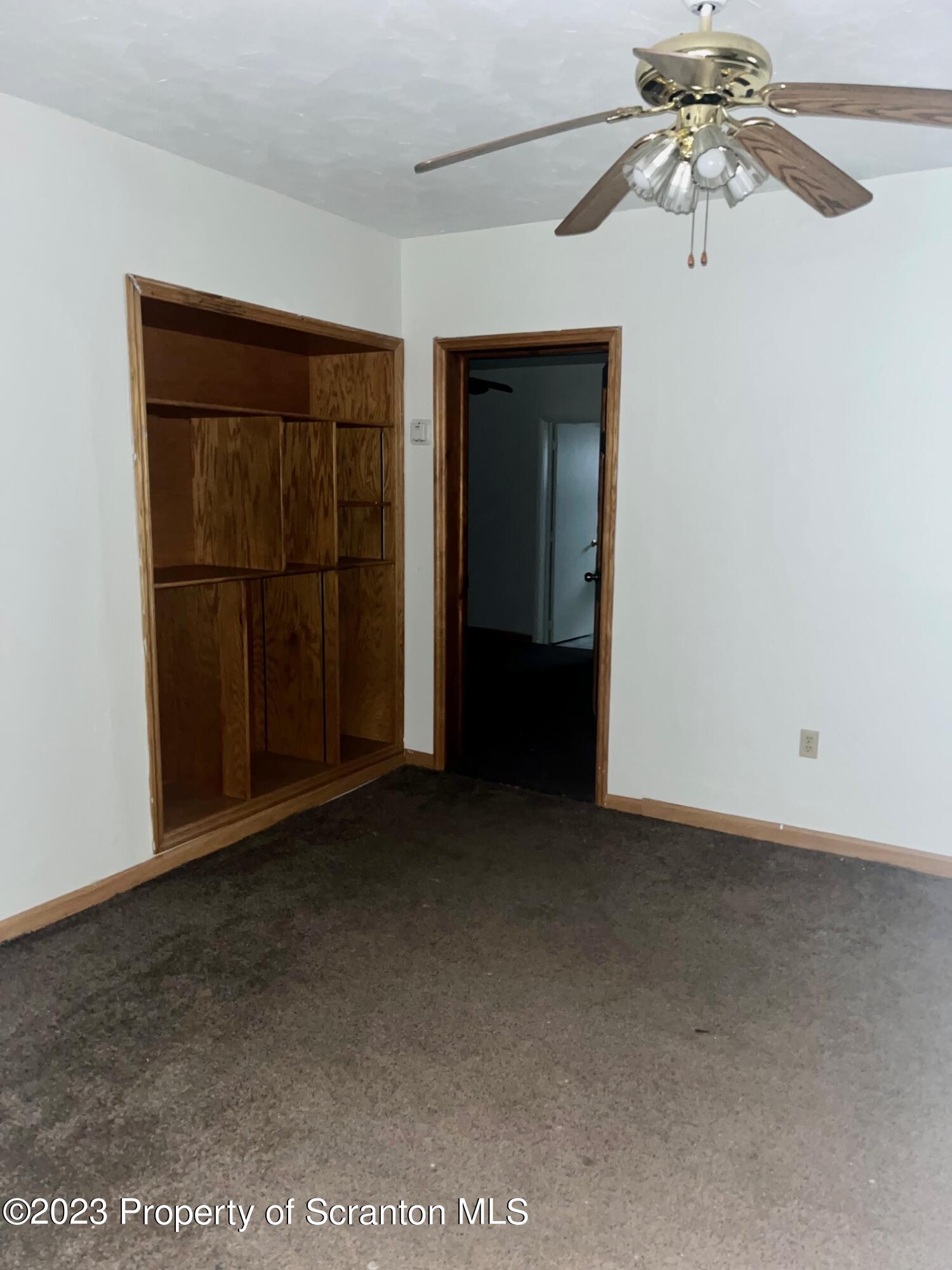 1803 Jackson Street Scranton, PA 18504 - Photo 4 of 8 an empty room with windows and ceiling fan