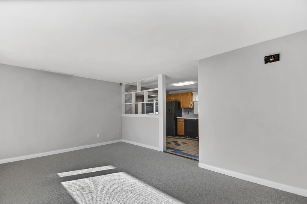 14 Bradford Road Hudson, MA 01749 - Photo 3 of 16 an empty room with wooden floor and a window