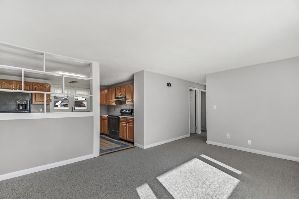 14 Bradford Road Hudson, MA 01749 - Photo 4 of 16 a view of a kitchen with an empty space and a window