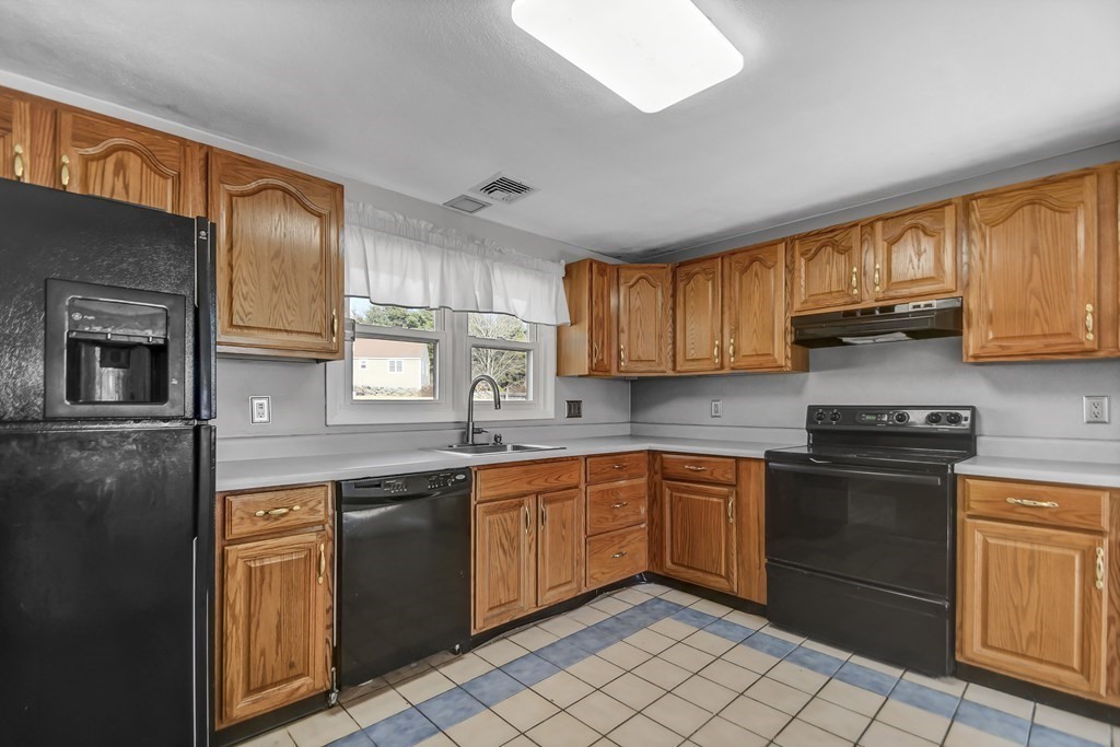 14 Bradford Road Hudson, MA 01749 - Photo 5 of 16 a kitchen with stainless steel appliances granite countertop a sink stove window and cabinets