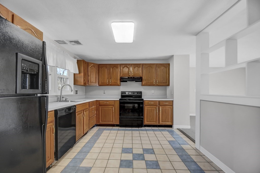 14 Bradford Road Hudson, MA 01749 - Photo 7 of 16 a large kitchen with a stove top oven