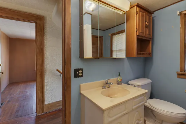 a bathroom with a toilet sink and mirror