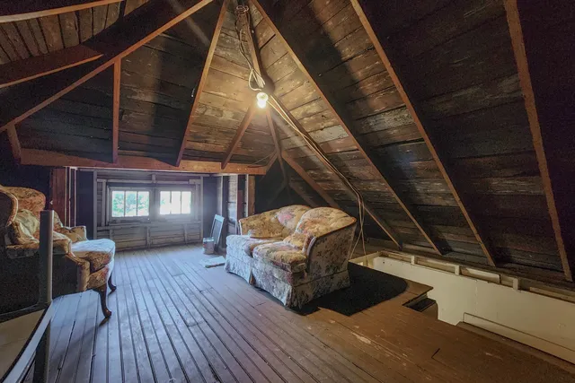 a view of a livingroom with furniture wooden floor and windows