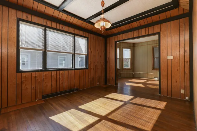 wooden floor with a bed