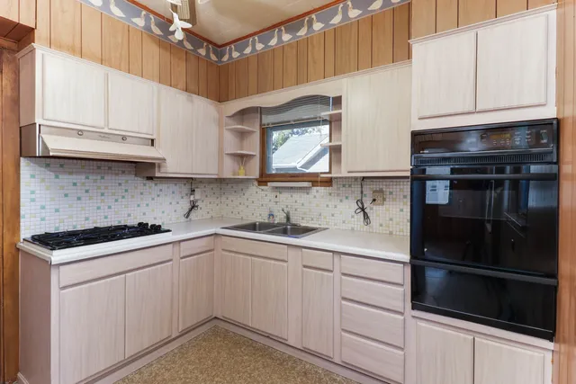 a kitchen with stainless steel appliances granite countertop a sink and cabinets