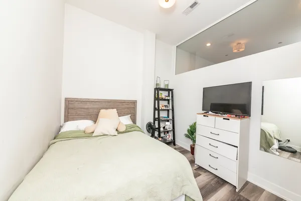 a bedroom with a bed and a flat screen tv