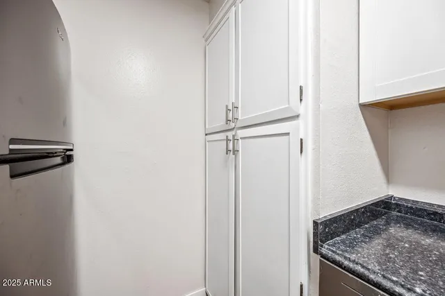 a view of a storage & utility room with a sink