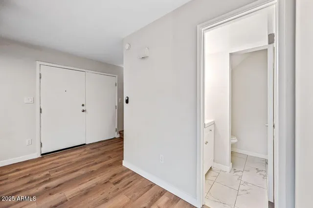 wooden floor with white walls