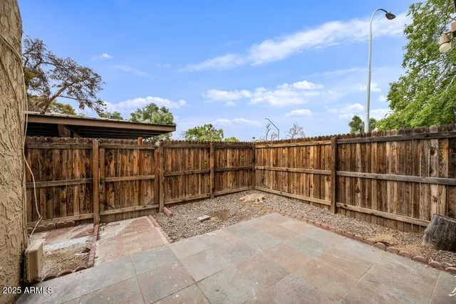 a view of a shaded area with wooden fence