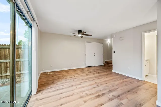 a view of a livingroom with a ceiling fan and window