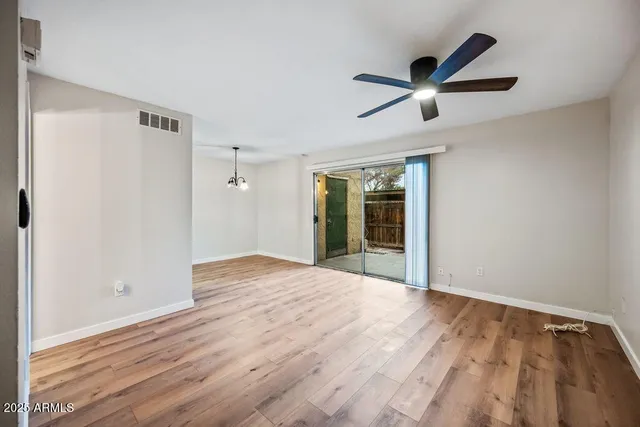 a view of an empty room and wooden floor