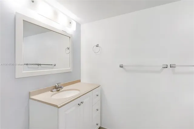a bathroom with a sink a mirror and shower