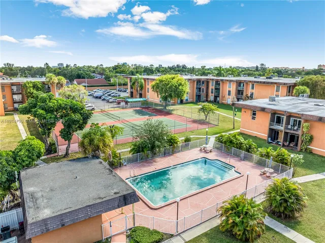 an aerial view of residential houses with outdoor space and street view