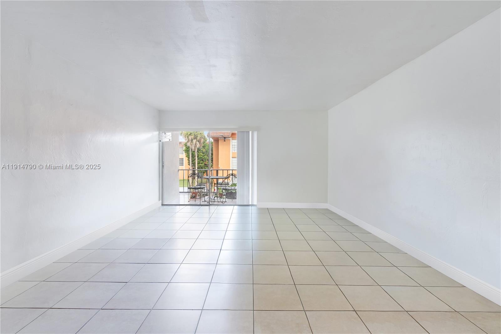 9423 Southwest 76th Street, Unit W21 Miami, FL 33173 - Photo 3 of 20 a view of an empty room and window