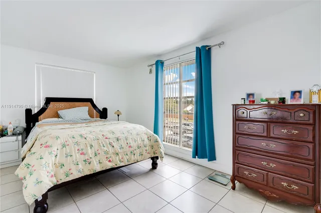 a bedroom with a bed and a mirror