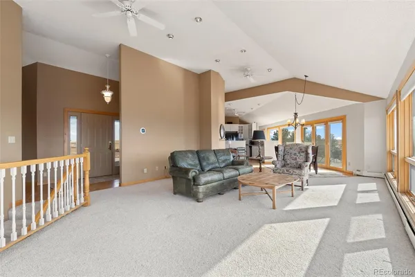 a living room with furniture and a chandelier